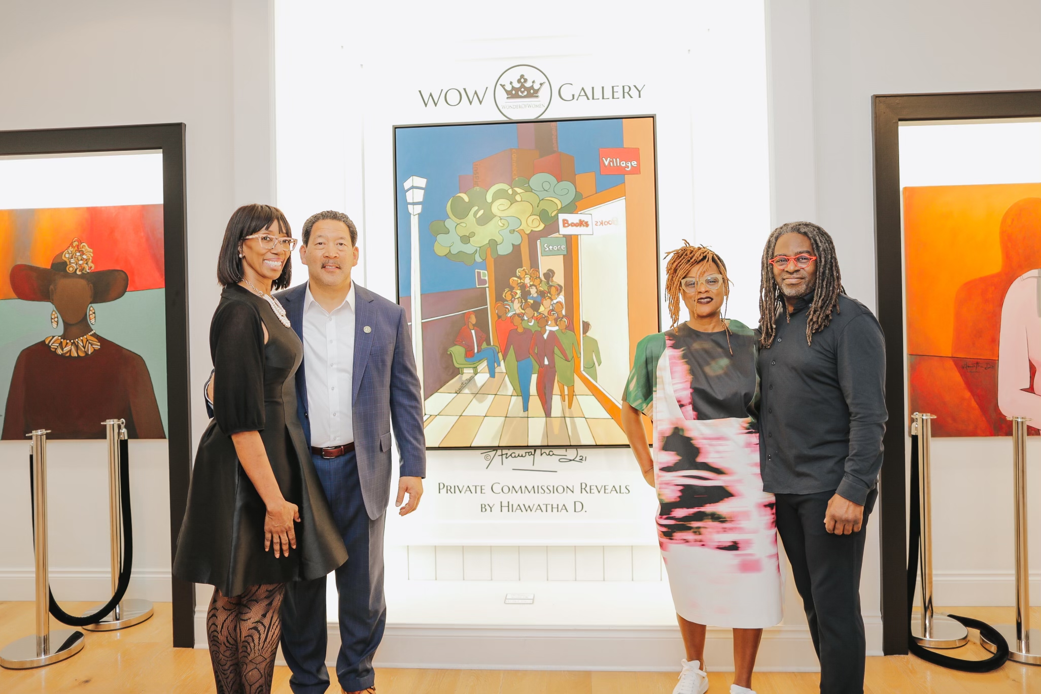 Alonda Williams, Big Brothers Big Sisters of Puget Sound President & CEO stands to the left of Seattle Mayor Bruce Harrell. In the center, the unveiled painting, BIG Futures, is mounted to the gallery wall. To the right of the painting stand WOW Gallery founder Veronica Very and renowned local artist Hiawatha D.